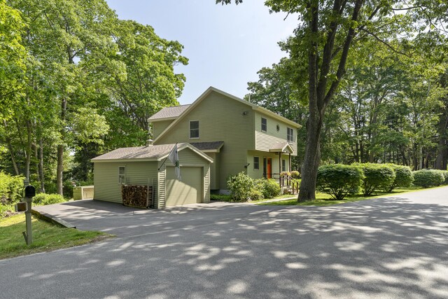 23 Stovers Point Rd, Harpswell, ME 04079 - view of front of home with asphalt driveway, an attached garage, and roof with shingles