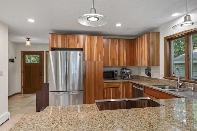 23 Stovers Point Rd, Harpswell, ME 04079 - kitchen with appliances with stainless steel finishes, brown cabinetry, healthy amount of natural light, light stone countertops, and recessed lighting