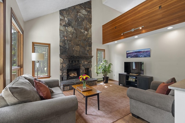 23 Stovers Point Rd, Harpswell, ME 04079 - living area with plenty of natural light, wood finished floors, a stone fireplace, and high vaulted ceiling