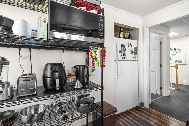 6 Winter St, Augusta, ME 04330 - kitchen featuring freestanding refrigerator, wood finished floors, stainless steel microwave, and crown molding