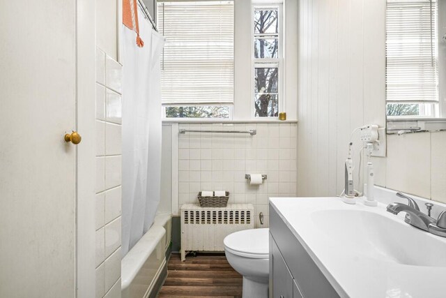 6 Winter St, Augusta, ME 04330 - bathroom featuring radiator heating unit, toilet, vanity, shower / bath combination with curtain, and wood finished floors
