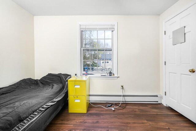 6 Winter St, Augusta, ME 04330 - bedroom with wood finished floors and a baseboard heating unit