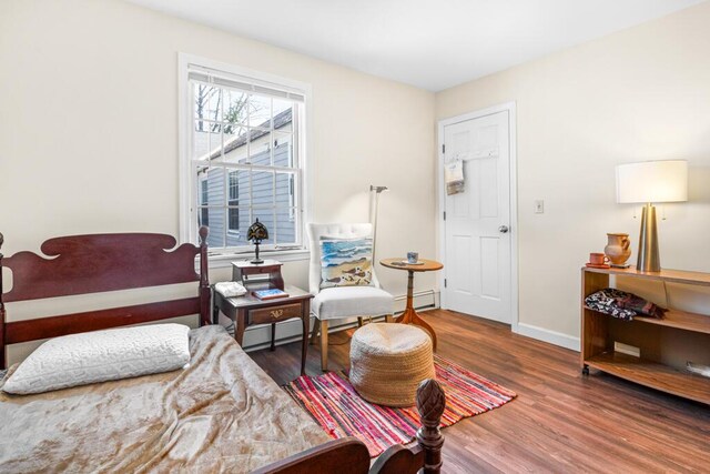 6 Winter St, Augusta, ME 04330 - bedroom with wood finished floors, a baseboard heating unit, and baseboards