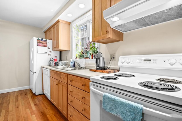 6 Winter St, Augusta, ME 04330 - kitchen with white appliances, wall chimney range hood, light wood finished floors, a sink, and light countertops