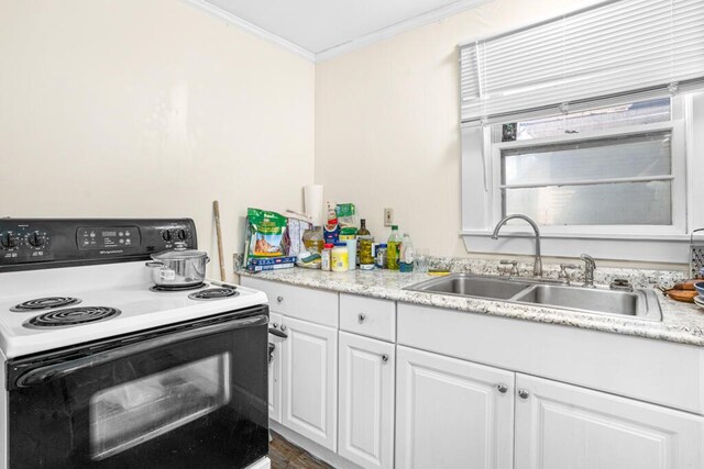 6 Winter St, Augusta, ME 04330 - kitchen with range with electric stovetop, a sink, crown molding, white cabinetry, and light countertops