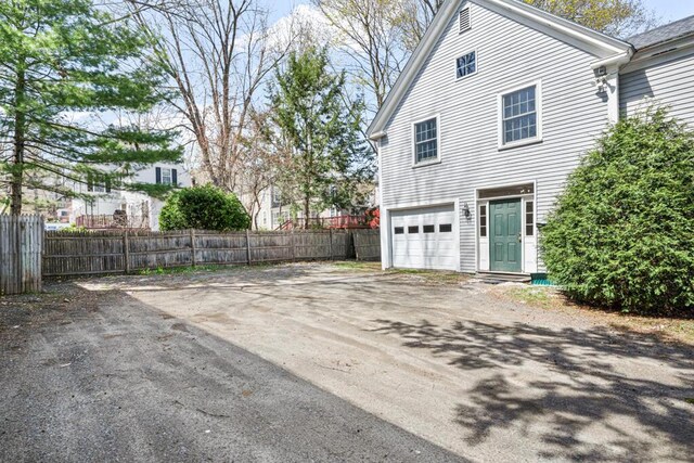 6 Winter St, Augusta, ME 04330 - view of side of property with an attached garage and dirt driveway