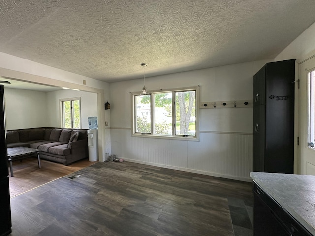 52 Rideout Ave, Lewiston, ME 04240 - living room featuring wood finished floors, wainscoting, and a textured ceiling