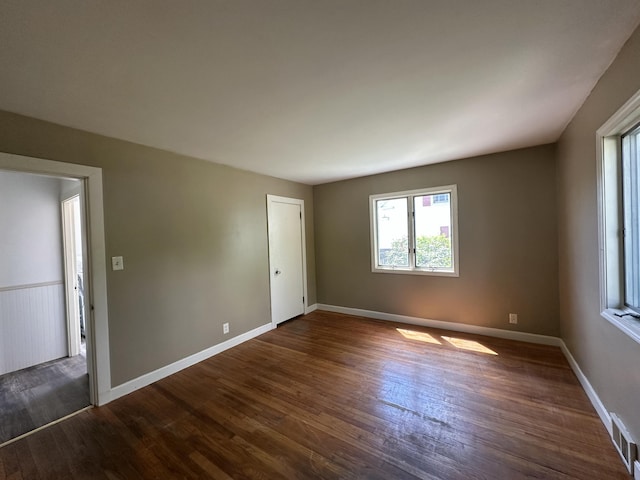 52 Rideout Ave, Lewiston, ME 04240 - spare room featuring plenty of natural light, dark wood-type flooring, and baseboards