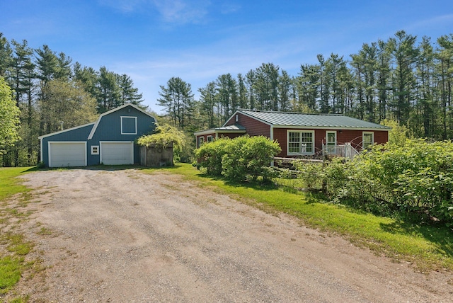 592 Old Stage Rd, Arrowsic, ME 04530 - view of front facade featuring a detached garage, driveway, an outdoor structure, a standing seam roof, and metal roof