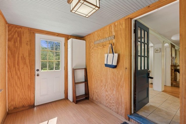 592 Old Stage Rd, Arrowsic, ME 04530 - interior space with wooden walls, light wood-style floors, arched walkways, and crown molding