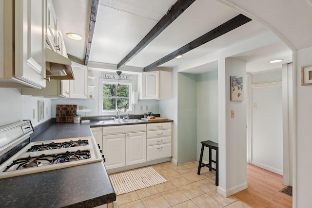 592 Old Stage Rd, Arrowsic, ME 04530 - kitchen featuring a sink, dark countertops, white cabinetry, and beamed ceiling