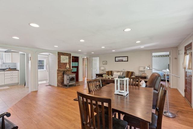 592 Old Stage Rd, Arrowsic, ME 04530 - dining room featuring arched walkways, recessed lighting, light wood finished floors, baseboards, and crown molding