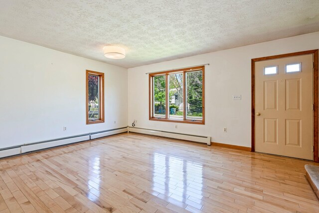 94 Thompson St, South Portland, ME 04106 - foyer entrance with healthy amount of natural light, light wood-style flooring, and a textured ceiling