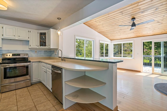 94 Thompson St, South Portland, ME 04106 - kitchen with appliances with stainless steel finishes, a sink, lofted ceiling, open shelves, and a peninsula