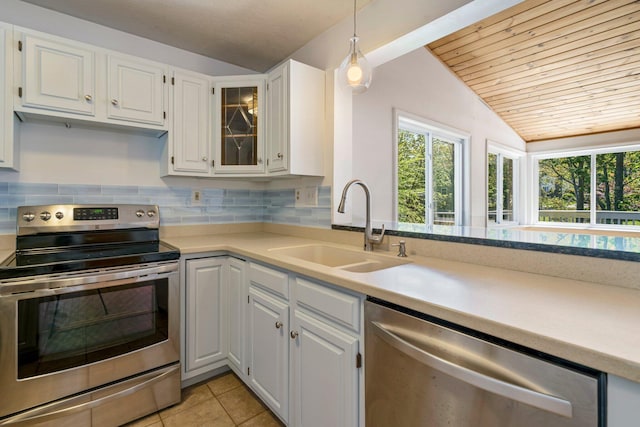 94 Thompson St, South Portland, ME 04106 - kitchen featuring stainless steel appliances, a sink, vaulted ceiling, white cabinets, and light countertops
