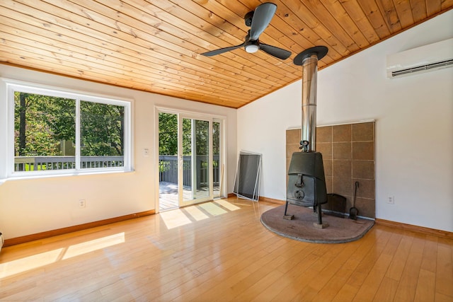 94 Thompson St, South Portland, ME 04106 - unfurnished living room featuring a wood stove, an AC wall unit, wooden ceiling, ceiling fan, and vaulted ceiling