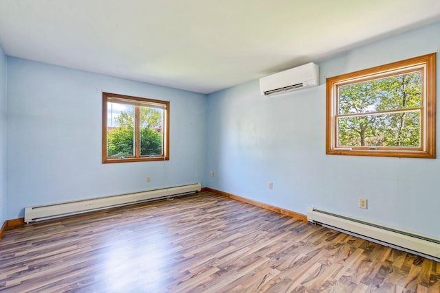 94 Thompson St, South Portland, ME 04106 - empty room featuring a wall mounted air conditioner, a baseboard radiator, baseboard heating, wood finished floors, and baseboards