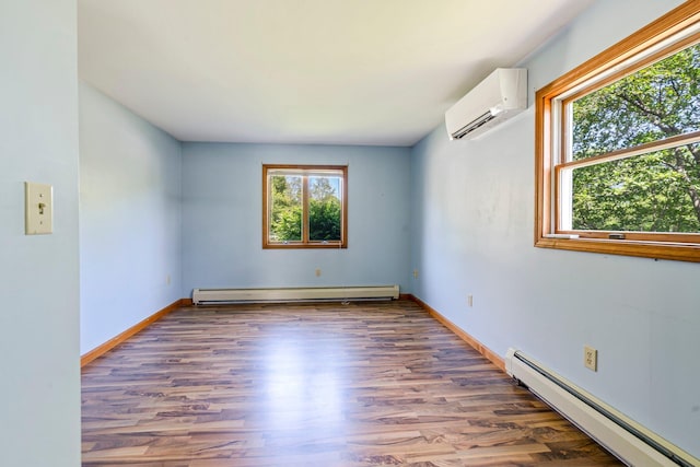 94 Thompson St, South Portland, ME 04106 - spare room featuring a baseboard heating unit, a wall mounted air conditioner, wood finished floors, and baseboards