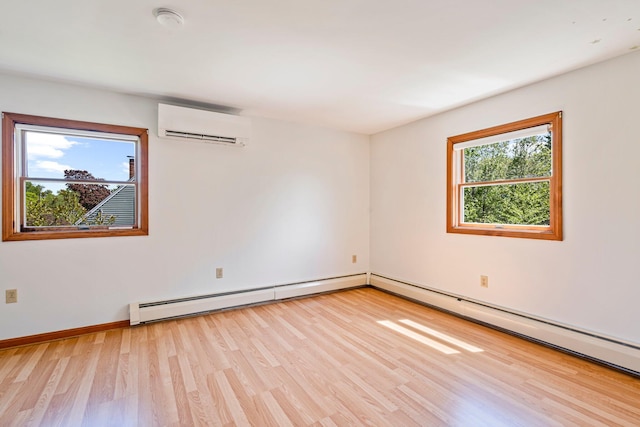 94 Thompson St, South Portland, ME 04106 - unfurnished room featuring a wall mounted air conditioner, baseboard heating, light wood-style floors, baseboards, and a smoke detector