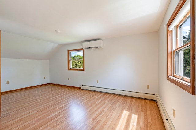 94 Thompson St, South Portland, ME 04106 - bonus room featuring light wood-style floors, a baseboard heating unit, a wall mounted AC, baseboards, and vaulted ceiling