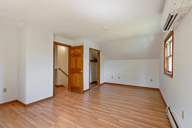 94 Thompson St, South Portland, ME 04106 - additional living space featuring a baseboard radiator, a wall mounted AC, light wood-style flooring, baseboards, and vaulted ceiling