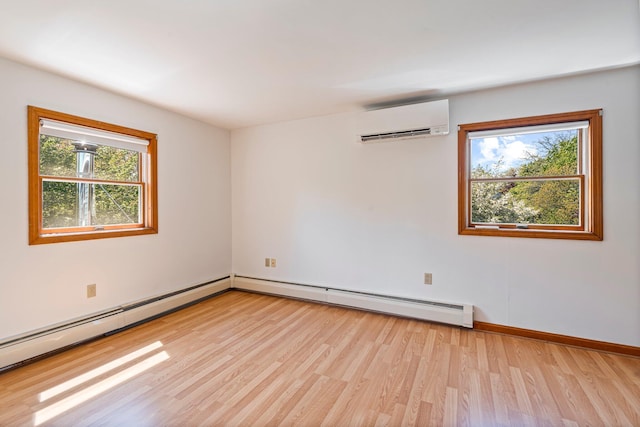 94 Thompson St, South Portland, ME 04106 - unfurnished room featuring a wall mounted air conditioner, light wood-type flooring, baseboard heating, and baseboards