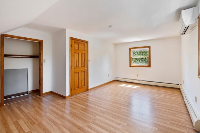 94 Thompson St, South Portland, ME 04106 - unfurnished bedroom with baseboard heating, light wood finished floors, and a wall unit AC