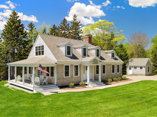 286 Atlantic Hwy, Northport, ME 04849 - view of front facade featuring a chimney, an outdoor structure, and a front yard