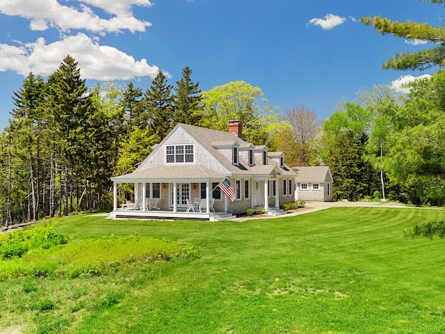 286 Atlantic Hwy, Northport, ME 04849 - view of front of home featuring a chimney, a front lawn, and a porch