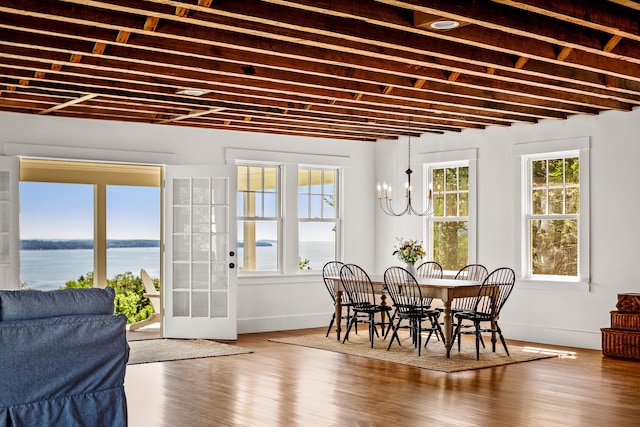 286 Atlantic Hwy, Northport, ME 04849 - dining space with a chandelier, wood finished floors, baseboards, and a water view