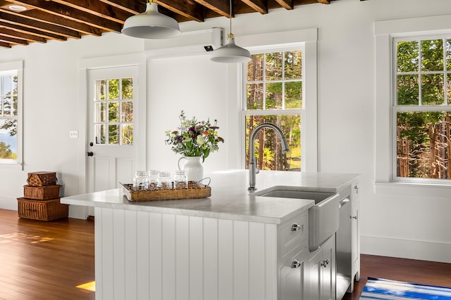 286 Atlantic Hwy, Northport, ME 04849 - kitchen with dark wood-style flooring, plenty of natural light, hanging light fixtures, light countertops, and beam ceiling