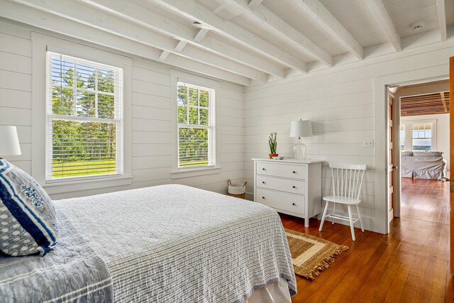 286 Atlantic Hwy, Northport, ME 04849 - bedroom with multiple windows, hardwood / wood-style floors, beamed ceiling, and wood walls