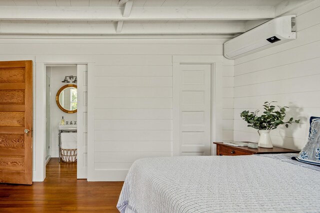 286 Atlantic Hwy, Northport, ME 04849 - bedroom with a wall mounted air conditioner, dark wood-style flooring, beamed ceiling, and wood walls