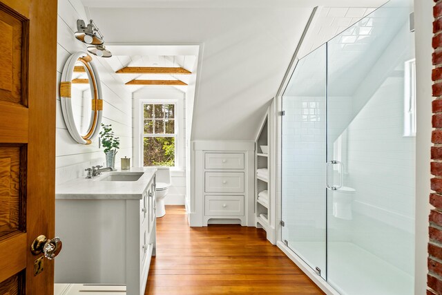 286 Atlantic Hwy, Northport, ME 04849 - full bathroom with toilet, vanity, wood finished floors, a stall shower, and vaulted ceiling