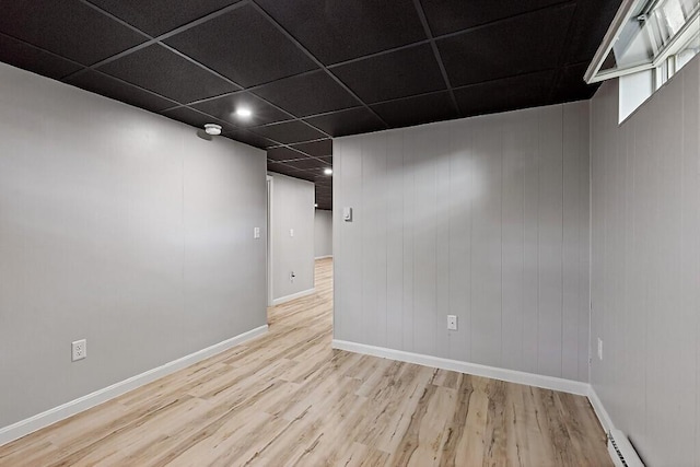 7 Philip Ave, Augusta, ME 04330 - finished below grade area with wood finished floors, baseboards, a baseboard heating unit, recessed lighting, and a paneled ceiling