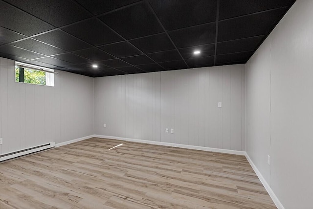 7 Philip Ave, Augusta, ME 04330 - basement with light wood finished floors, a baseboard heating unit, baseboards, and a drop ceiling