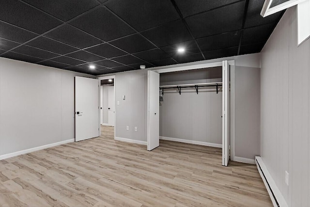 7 Philip Ave, Augusta, ME 04330 - unfurnished bedroom featuring wood finished floors, baseboard heating, a drop ceiling, a closet, and baseboards