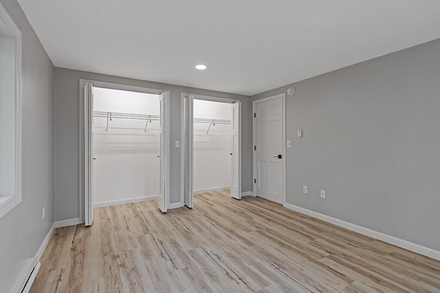 7 Philip Ave, Augusta, ME 04330 - unfurnished bedroom featuring light wood-type flooring, baseboards, a baseboard heating unit, multiple closets, and recessed lighting