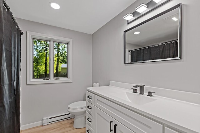 7 Philip Ave, Augusta, ME 04330 - full bathroom featuring a baseboard heating unit, vanity, toilet, wood finished floors, and baseboards