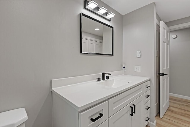 7 Philip Ave, Augusta, ME 04330 - half bathroom featuring vanity, toilet, wood finished floors, and baseboards