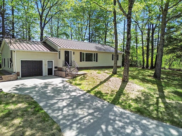7 Philip Ave, Augusta, ME 04330 - split level home with a standing seam roof, an attached garage, concrete driveway, and metal roof