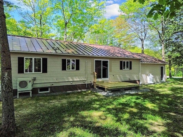 7 Philip Ave, Augusta, ME 04330 - back of house featuring a standing seam roof, ac unit, a lawn, a wooden deck, and metal roof