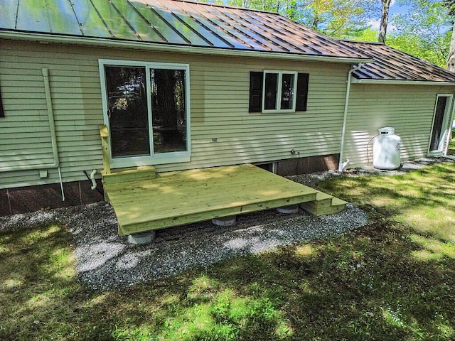 7 Philip Ave, Augusta, ME 04330 - rear view of house with a standing seam roof, metal roof, and a wooden deck