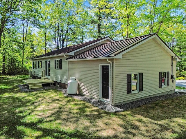 7 Philip Ave, Augusta, ME 04330 - back of property featuring a standing seam roof, metal roof, and a lawn