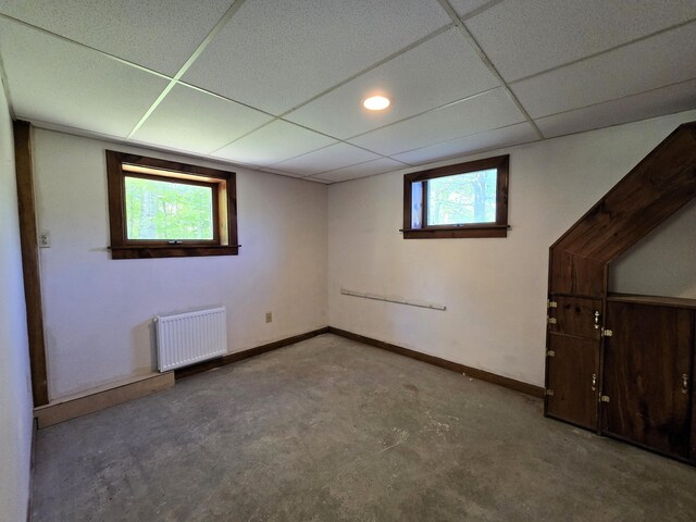 237 Bangor Rd, Unity, ME 04988 - basement featuring radiator, a drop ceiling, and baseboards