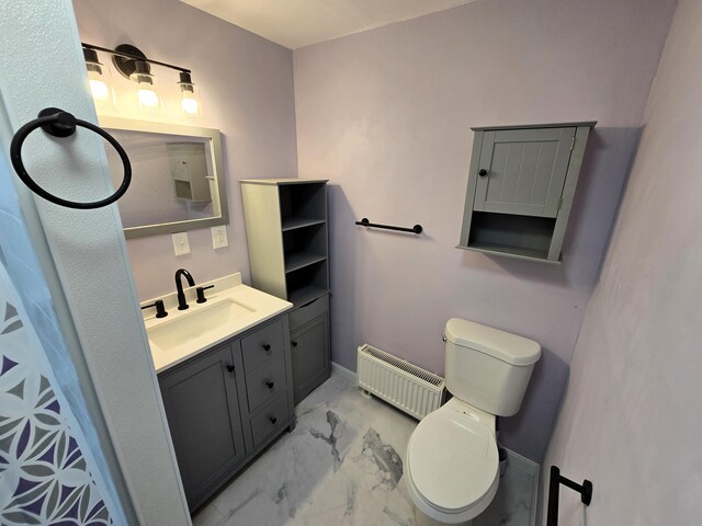 237 Bangor Rd, Unity, ME 04988 - full bath with radiator, toilet, marble look tile flooring, vanity, and baseboards