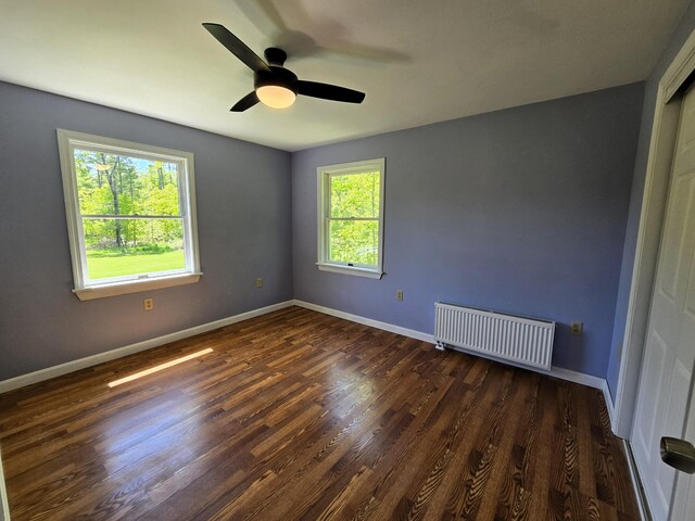237 Bangor Rd, Unity, ME 04988 - spare room with radiator heating unit, dark wood-type flooring, ceiling fan, and baseboards