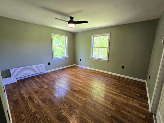 237 Bangor Rd, Unity, ME 04988 - empty room featuring radiator heating unit, dark wood finished floors, ceiling fan, and baseboards