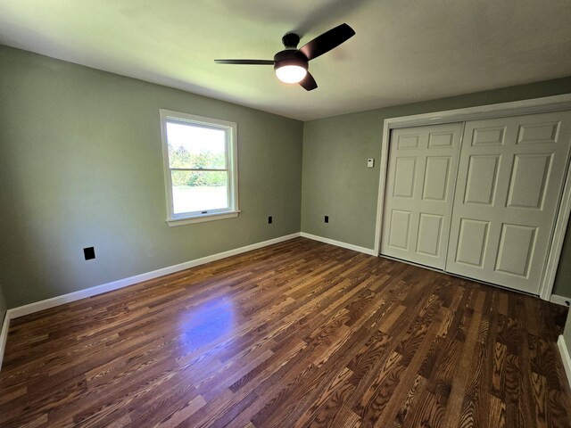 237 Bangor Rd, Unity, ME 04988 - unfurnished bedroom with dark wood-type flooring, baseboards, a closet, and ceiling fan