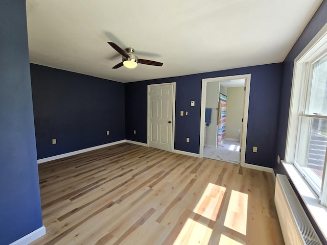 237 Bangor Rd, Unity, ME 04988 - unfurnished bedroom featuring light wood-style flooring, multiple windows, and ceiling fan